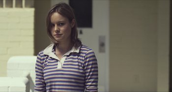 Movie still from “Short Term 12” (2013), directed by Destin Daniel Cretton – A woman in a striped shirt is standing in a room; Close Up shot, Over the shoulder angle