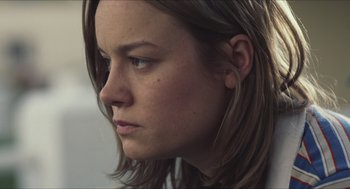 Movie still from “Short Term 12” (2013), directed by Destin Daniel Cretton – A person's face with long brown hair; Close Up shot, Over the shoulder angle