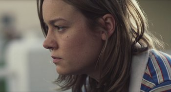Movie still from “Short Term 12” (2013), directed by Destin Daniel Cretton – A person's face with long brown hair; Close Up shot, Low angle