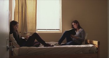Movie still from “Short Term 12” (2013), directed by Destin Daniel Cretton – Two women sitting on a bed reading a book; Medium shot, Low angle