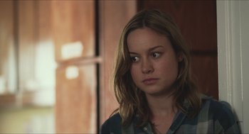 Movie still from “Short Term 12” (2013), directed by Destin Daniel Cretton – A woman with long brown hair wearing a plaid shirt; Close Up shot, Over the shoulder angle