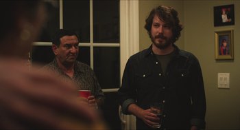 Movie still from “Short Term 12” (2013), directed by Destin Daniel Cretton – Two men standing next to each other holding drinks; Medium shot, Over the shoulder angle