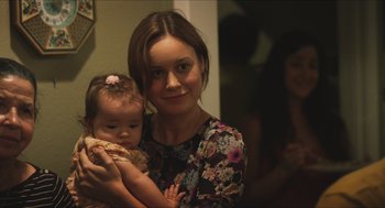 Movie still from “Short Term 12” (2013), directed by Destin Daniel Cretton – A woman holding a baby in her arms; Close Up shot, Over the shoulder angle