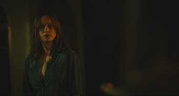 Movie still from “Short Term 12” (2013), directed by Destin Daniel Cretton – A woman in a dark room with a dark background; Close Up shot, Over the shoulder angle