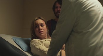 Movie still from “Short Term 12” (2013), directed by Destin Daniel Cretton – A woman sitting in a hospital bed next to a man; Medium shot, Over the shoulder angle
