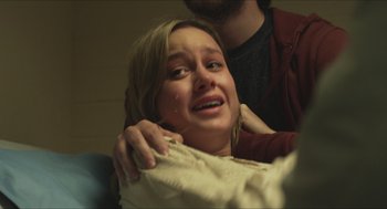 Movie still from “Short Term 12” (2013), directed by Destin Daniel Cretton – A young woman crying while holding a blanket; Close Up shot, Over the shoulder angle