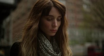 Movie still from “Side Effects” (2013), directed by Steven Soderbergh – A beautiful young lady with long brown hair wearing a scarf; Close Up shot, Low angle