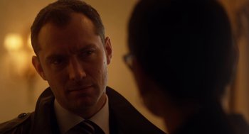 Movie still from “Side Effects” (2013), directed by Steven Soderbergh – A person wearing a suit and tie; Close Up shot, Over the shoulder angle
