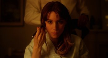 Movie still from “Side Effects” (2013), directed by Steven Soderbergh – A woman with long brown hair is looking at the camera; Close Up shot, Over the shoulder angle