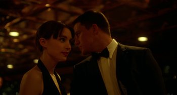 Movie still from “Side Effects” (2013), directed by Steven Soderbergh – A man and a woman in tuxedos standing next to each other; Close Up shot, Over the shoulder angle