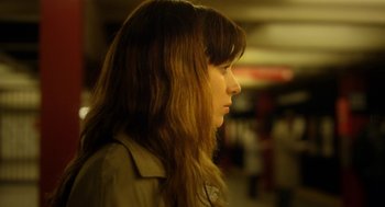 Movie still from “Side Effects” (2013), directed by Steven Soderbergh – A woman with long brown hair looking to the side; Close Up shot, Over the shoulder angle