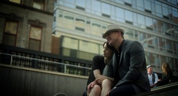 Movie still from “Side Effects” (2013), directed by Steven Soderbergh – A man and a woman sitting next to each other on a bench; Medium shot, Low angle