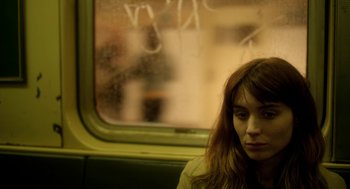 Movie still from “Side Effects” (2013), directed by Steven Soderbergh – A woman sitting on a train looking out the window; Close Up shot, Over the shoulder angle