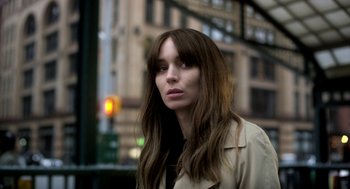 Movie still from “Side Effects” (2013), directed by Steven Soderbergh – A woman with long brown hair wearing a trench coat; Close Up shot, High angle