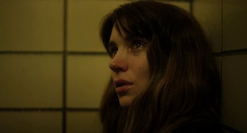 Movie still from “Side Effects” (2013), directed by Steven Soderbergh – A person with long brown hair; Close Up shot, Low angle
