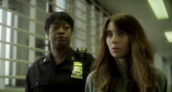 Movie still from “Side Effects” (2013), directed by Steven Soderbergh – A police officer and a woman standing next to each other; Close Up shot, Over the shoulder angle