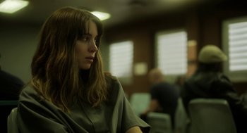 Movie still from “Side Effects” (2013), directed by Steven Soderbergh – A woman sitting in front of a group of people; Close Up shot, Over the shoulder angle