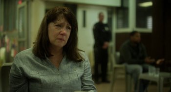 Movie still from “Side Effects” (2013), directed by Steven Soderbergh – A woman sitting in front of two men in a room; Close Up shot, Over the shoulder angle