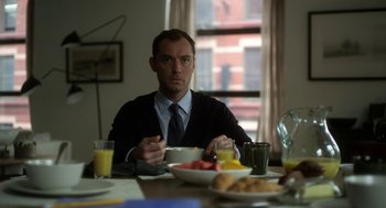 Movie still from “Side Effects” (2013), directed by Steven Soderbergh – A man sitting at a table with a bowl of fruit; Medium shot, Over the shoulder angle