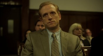Movie still from “Side Effects” (2013), directed by Steven Soderbergh – A man wearing a suit and tie in a courtroom; Close Up shot, Low angle