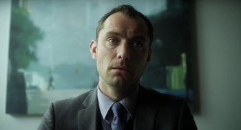 Movie still from “Side Effects” (2013), directed by Steven Soderbergh – A person wearing a suit and tie; Close Up shot, Low angle