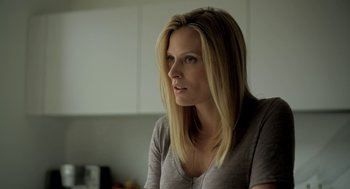 Movie still from “Side Effects” (2013), directed by Steven Soderbergh – A woman sitting in a kitchen looking to her left; Close Up shot, Low angle