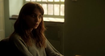 Movie still from “Side Effects” (2013), directed by Steven Soderbergh – A woman sitting in front of an open window; Close Up shot, Over the shoulder angle