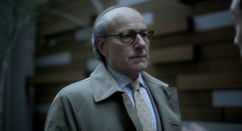 Movie still from “Side Effects” (2013), directed by Steven Soderbergh – An older man wearing glasses and wearing a tie; Close Up shot, Low angle