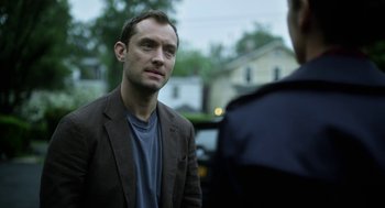 Movie still from “Side Effects” (2013), directed by Steven Soderbergh – A man standing next to a police officer; Close Up shot, Over the shoulder angle