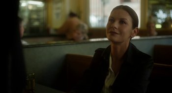 Movie still from “Side Effects” (2013), directed by Steven Soderbergh – A woman sitting in a booth at a restaurant; Close Up shot, Over the shoulder angle