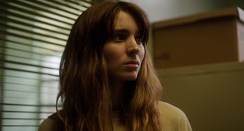 Movie still from “Side Effects” (2013), directed by Steven Soderbergh – A woman with long brown hair looking to her left; Close Up shot, Low angle