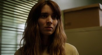 Movie still from “Side Effects” (2013), directed by Steven Soderbergh – A person with long brown hair; Close Up shot, Low angle