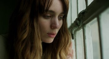 Movie still from “Side Effects” (2013), directed by Steven Soderbergh – A person with long hair near a faucet; Close Up shot, Low angle