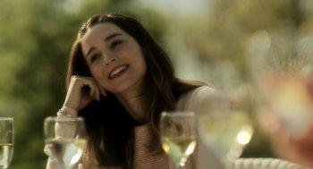 Movie still from “Side Effects” (2013), directed by Steven Soderbergh – A beautiful young lady sitting at a table with wine glasses; Close Up shot, Over the shoulder angle