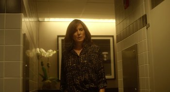 Movie still from “Side Effects” (2013), directed by Steven Soderbergh – A woman standing in a room next to a wall; Medium shot, Over the shoulder angle