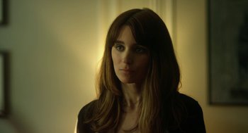 Movie still from “Side Effects” (2013), directed by Steven Soderbergh – A beautiful woman with long brown hair wearing a black jacket; Close Up shot, Over the shoulder angle