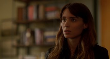 Movie still from “Side Effects” (2013), directed by Steven Soderbergh – A beautiful young woman with long brown hair and wearing a leather jacket; Close Up shot, Over the shoulder angle