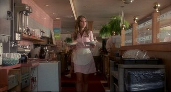 Movie still from “Sideways” (2004), directed by Alexander Payne – A woman holding a tray of food while wearing a white apron; Medium shot, Low angle