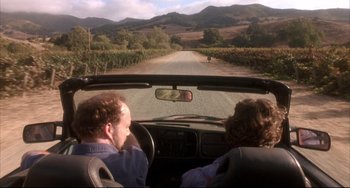 Movie still from “Sideways” (2004), directed by Alexander Payne – A man and a woman in the back seat of a car; Wide shot, High angle