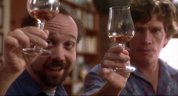 Movie still from “Sideways” (2004), directed by Alexander Payne – A man holding a glass of wine in his hand; Close Up shot, Low angle