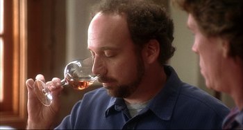 Movie still from “Sideways” (2004), directed by Alexander Payne – A man drinking a glass of wine from a wine glass; Close Up shot, Over the shoulder angle