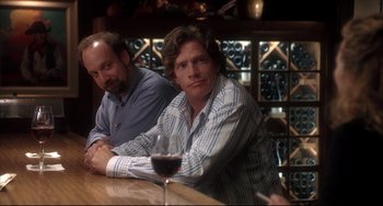 Movie still from “Sideways” (2004), directed by Alexander Payne – Two men sitting at a table with a glass of wine; Medium shot, Over the shoulder angle