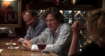 Movie still from “Sideways” (2004), directed by Alexander Payne – Two men sitting at a table with a glass of red wine; Medium shot, Over the shoulder angle