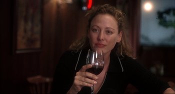 Movie still from “Sideways” (2004), directed by Alexander Payne – A woman holding a glass of red wine in her hand; Close Up shot, Over the shoulder angle