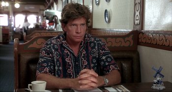 Movie still from “Sideways” (2004), directed by Alexander Payne – A man sitting at a table in front of a plate; Medium shot, Over the shoulder angle