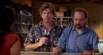 Movie still from “Sideways” (2004), directed by Alexander Payne – A man standing next to another man holding a glass of wine; Medium shot, Over the shoulder angle