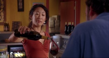 Movie still from “Sideways” (2004), directed by Alexander Payne – A woman pouring a glass of red wine into a wine glass; Close Up shot, Over the shoulder angle