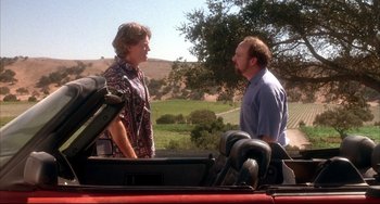 Movie still from “Sideways” (2004), directed by Alexander Payne – A man and a woman standing next to each other in the back of a truck; Medium shot, Over the shoulder angle