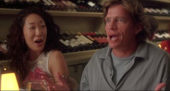 Movie still from “Sideways” (2004), directed by Alexander Payne – A man and a woman in front of a wine cellar; Close Up shot, Over the shoulder angle