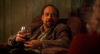 Movie still from “Sideways” (2004), directed by Alexander Payne – A man sitting in a chair holding a glass of wine; Close Up shot, High angle